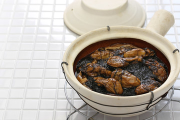braised dried oysters with black moss (ho see fat choy ) in pot, traditional chinese new year dish