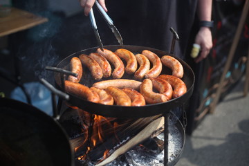 Close up image of tasty pork sausages cooking on the grill. Street food.