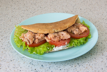 Pancake with oatmeal with red fish, tomato and herbs