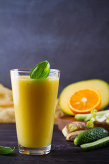 Mango Orange Ginger Cucumber and Celery Smoothie. Fruit and Vegetable Smoothie - healthy diet and detox drink. vertical