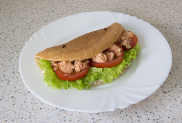 Pancake with oatmeal with red fish, tomato and herbs