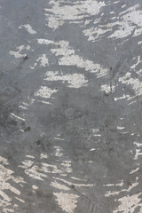 texture of an old grey cement wall with scratch and stain.