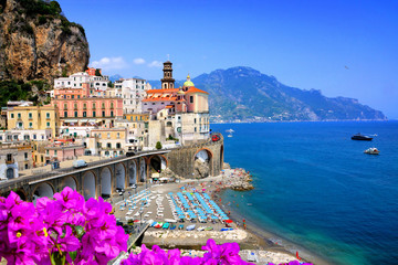 Scenic village along the Amalfi Coast of Italy. View of Atrani with flowers against the blue sea...