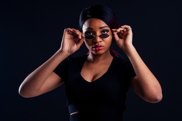 portrait african american beautiful woman creative hair coloring dye purple color on white background in studio sexy spy in a black t-shirt