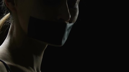 Man taping lady mouth, sexual slavery victim, human rights violation, kidnapping