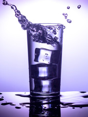 Splash water in a glass with ice
