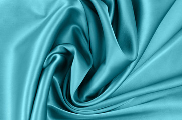 Background from satin fabric of green blue color.