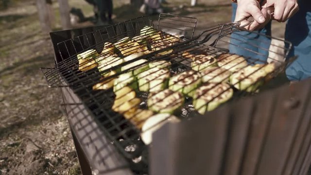 Vegetable barbecue zucchini fried on charcoal. Summer picnic with cooking healthy vegetarian food in nature
