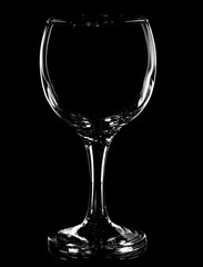 Glass goblet with highlights on black background