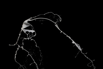 White paint splash isolated on black background.