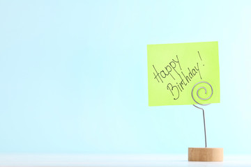 Paper with text Happy Birthday on blue background