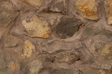 Wall of cemented stones of different sizes