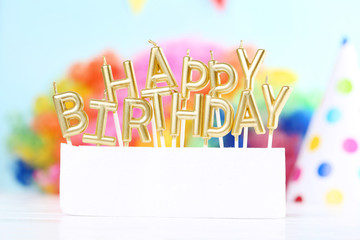 Happy Birthday candles on colorful background