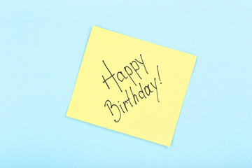 Paper with text Happy Birthday on blue background