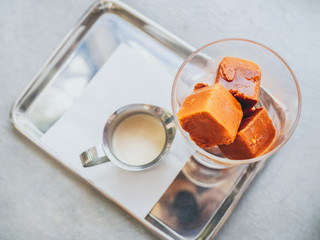 Thai milk tea ice cubes in glass