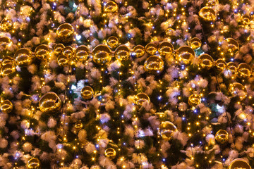 Decorations on the tree with a lot of yellow balls