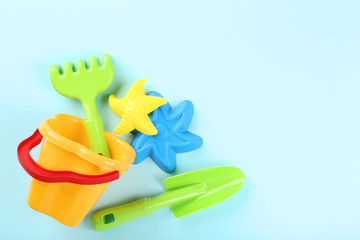 Plastic beach toys on blue background