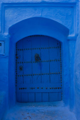 Traditional moroccan wooden door as an architectural detail in the streets of the Blue City, Chefchaouen, Morocco