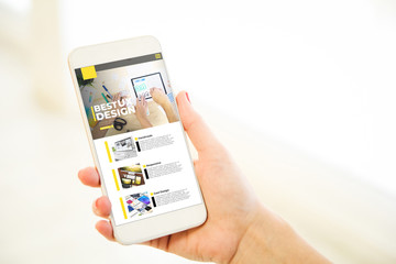 Woman holding a pink gold blank smartphone showing ux design website