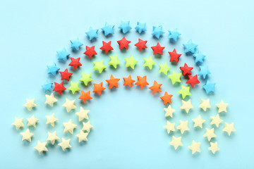 Colorful paper stars on blue background