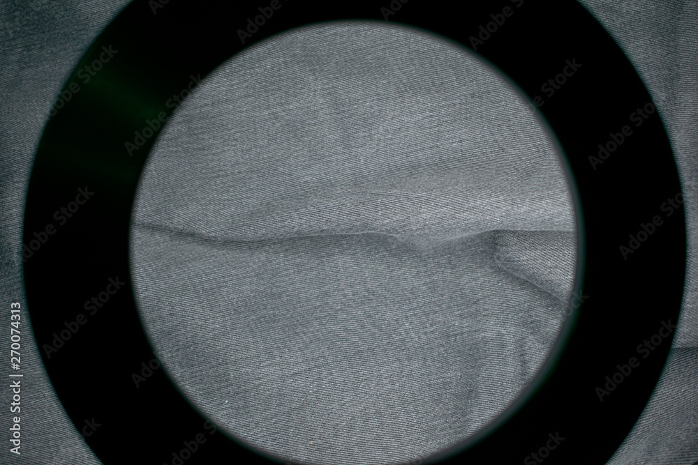 Poster denim material in the frame of the round frame of the lamp.