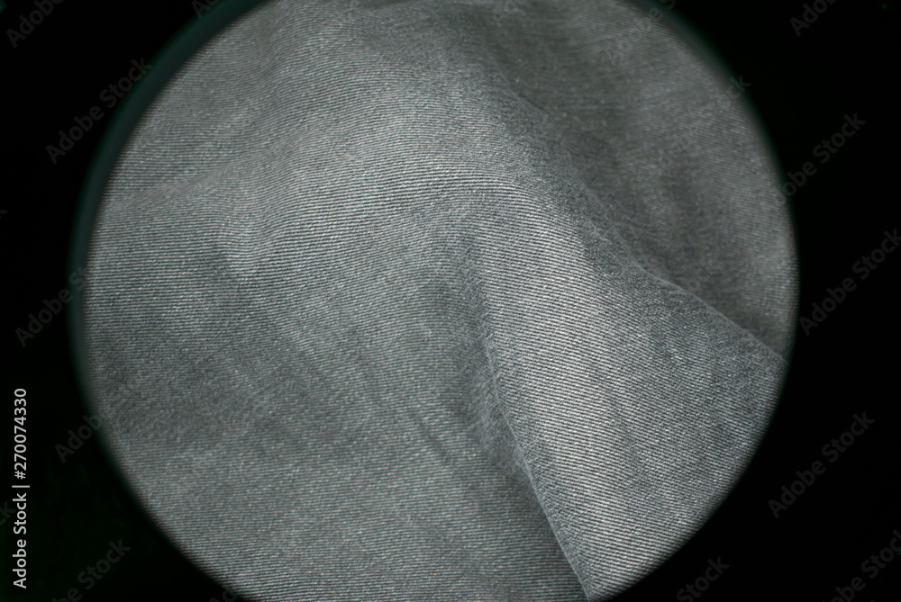 Poster denim material in the frame of the round frame of the lamp.