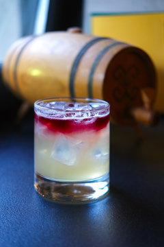 Soft focus photo of New york sour cocktail on bar counter. Image with shallow depth of field and contains a little noise due to poor lighting conditions.