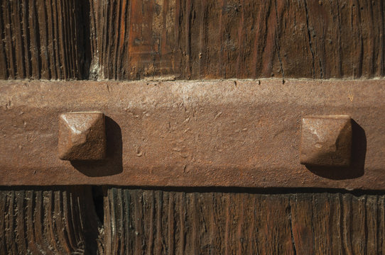 Iron hinge with studs in an old wooden door at Caceres