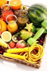 Healthy lifestyle concept. healthy fruits, smoothies and sport fitness equipment, dumbbells and jumping rope
