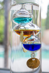 Floating glass liquid Galileo thermometer