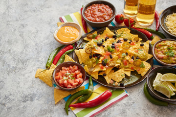Mexican nachos tortilla chips with black bean, jalapeno, guacamole