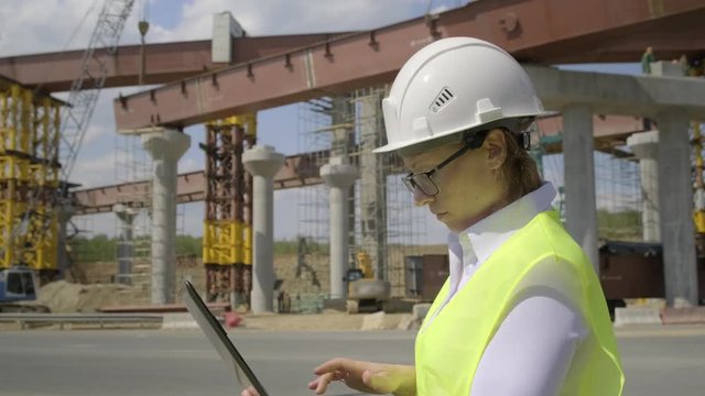 accountant makes estimate on construction site using laptop. Close-up.