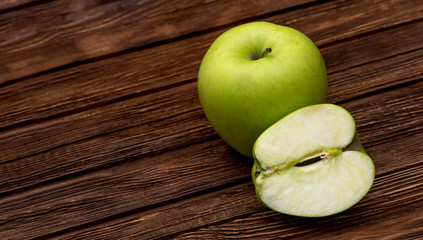 Green apples on dark brown wooden background. Summer fruits. Natural vitamins. Healthy food.