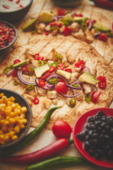 Freshly made healthy corn tortillas with grilled chicken fillet, big avocado slices