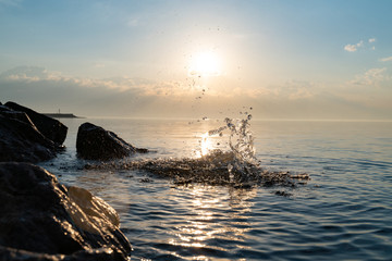 Obraz na płótnie Canvas big beautiful splash of water in the sea at sunset. natural desktop background