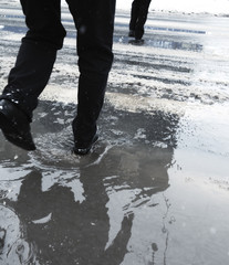 Ordinary anonymous people on streets of city after a snow storm.