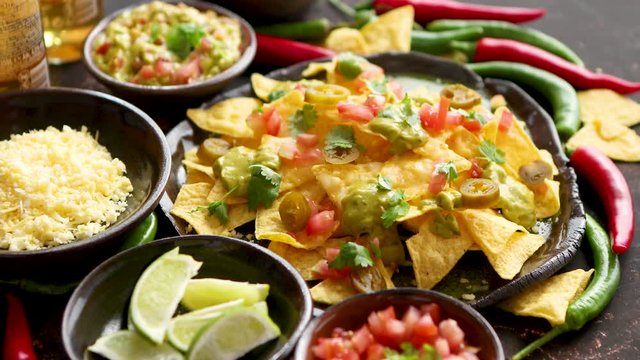Tasty mexican nachos chips served on ceramic plate