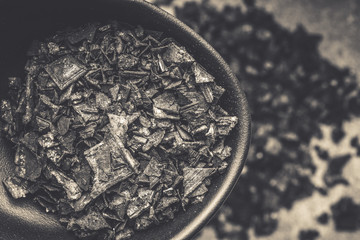 Black Salt Crystals on Dark Texture Background