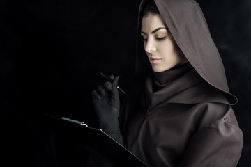 woman in death costume holding clipboard on black