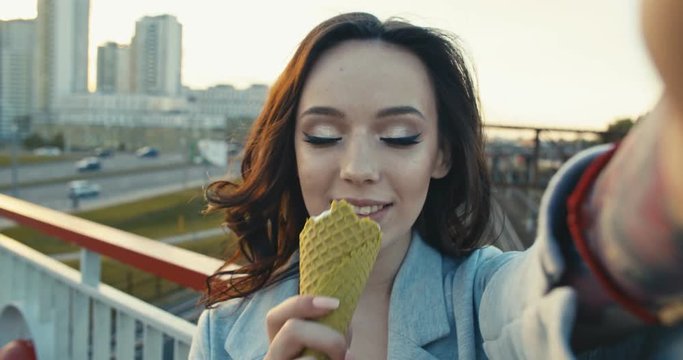 woman eating ice cream and taking selfie