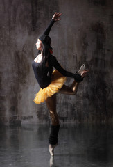Obraz na płótnie Canvas Young beautiful ballerina is posing in studio
