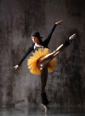 Obraz na płótnie Canvas Young beautiful ballerina is posing in studio