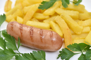 Street food. A dish of sausages and fried potatoes.