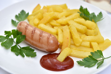 Street food. A dish of sausages and fried potatoes.