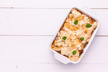 Traditional Italian Lasagna With Minced Beef, Tomato Sauce and Green Basil on White Background