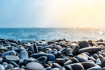 Sea stones and waves on the beach. Summer background.