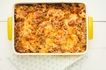 Lasagna Bolognese with Beef, Cheese and Tomato Sauce on Rustic White Table