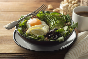 Healthy food. Eggs, quinoa, avocado, green salad, black olives. Wooden table. diet, lose weight.