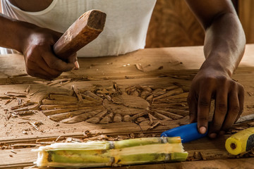 african man doing his work makes a carver door