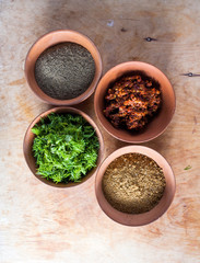 Obraz na płótnie Canvas Spices in the bowls closeup on table
